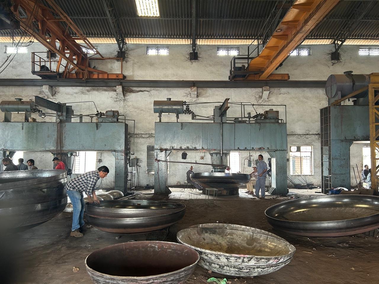 Multiple dished end orders in various stages of completion